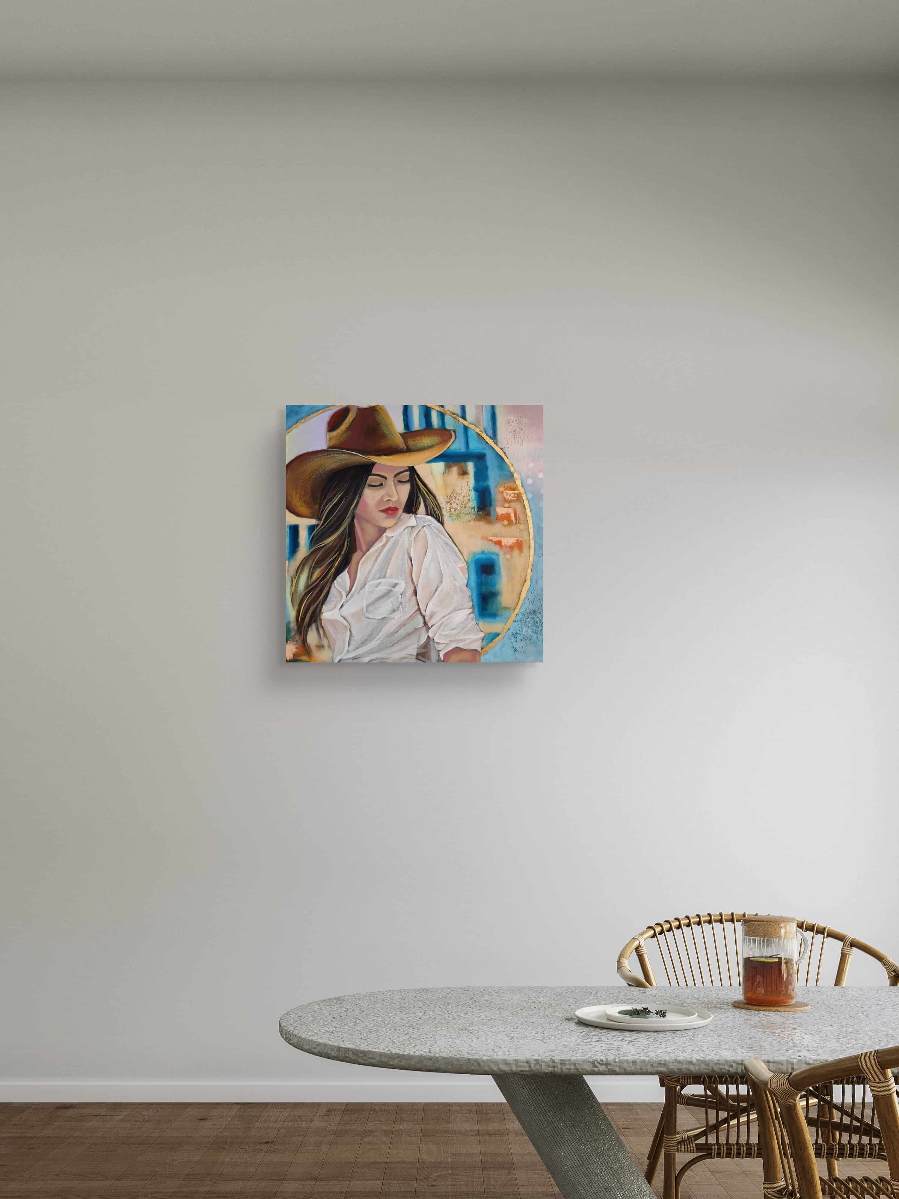 Painting of a woman wearing a hat on a wall above a dining table.