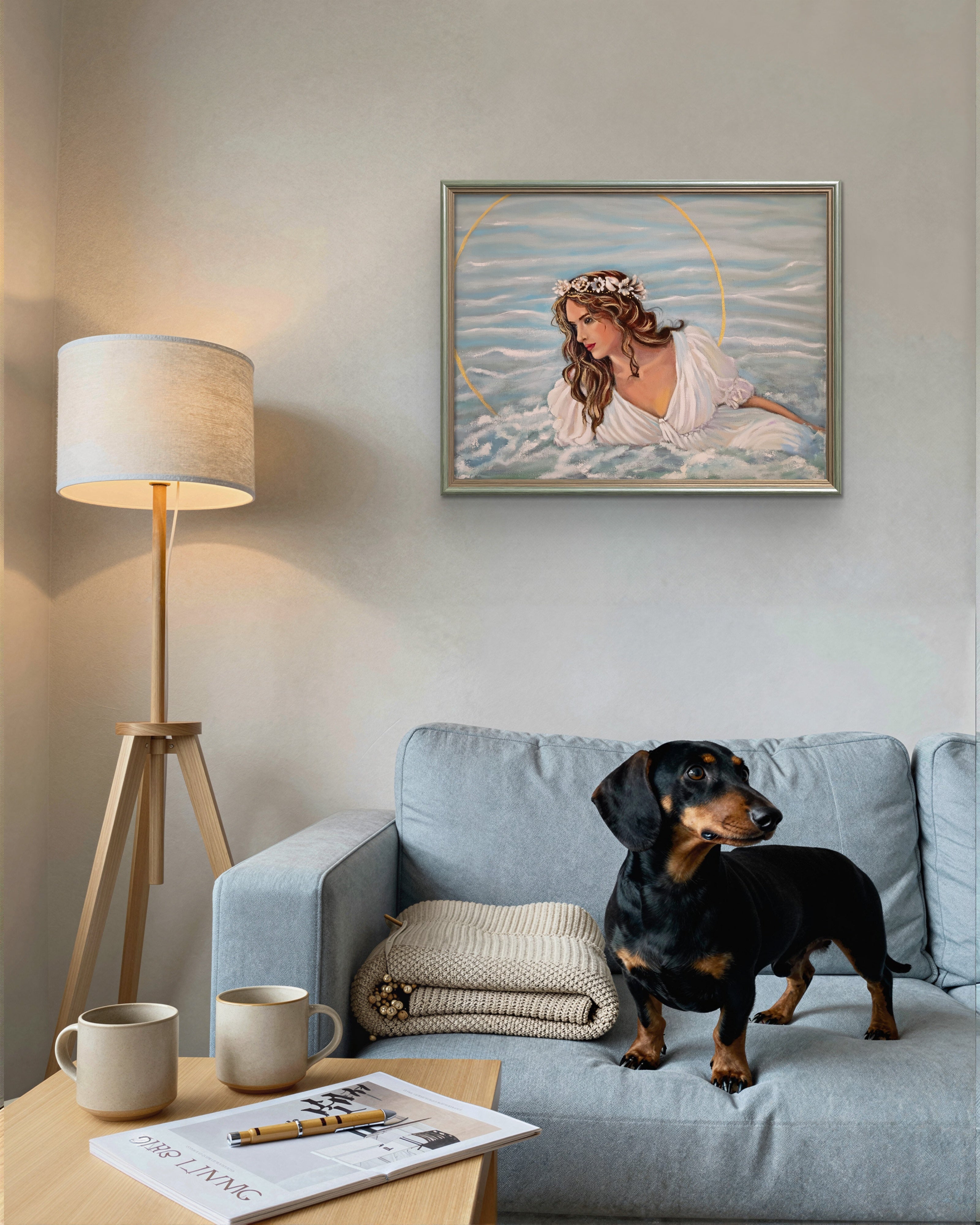Dog sitting on a couch in a living room with a lamp, coffee mugs, and a painting on the wall.