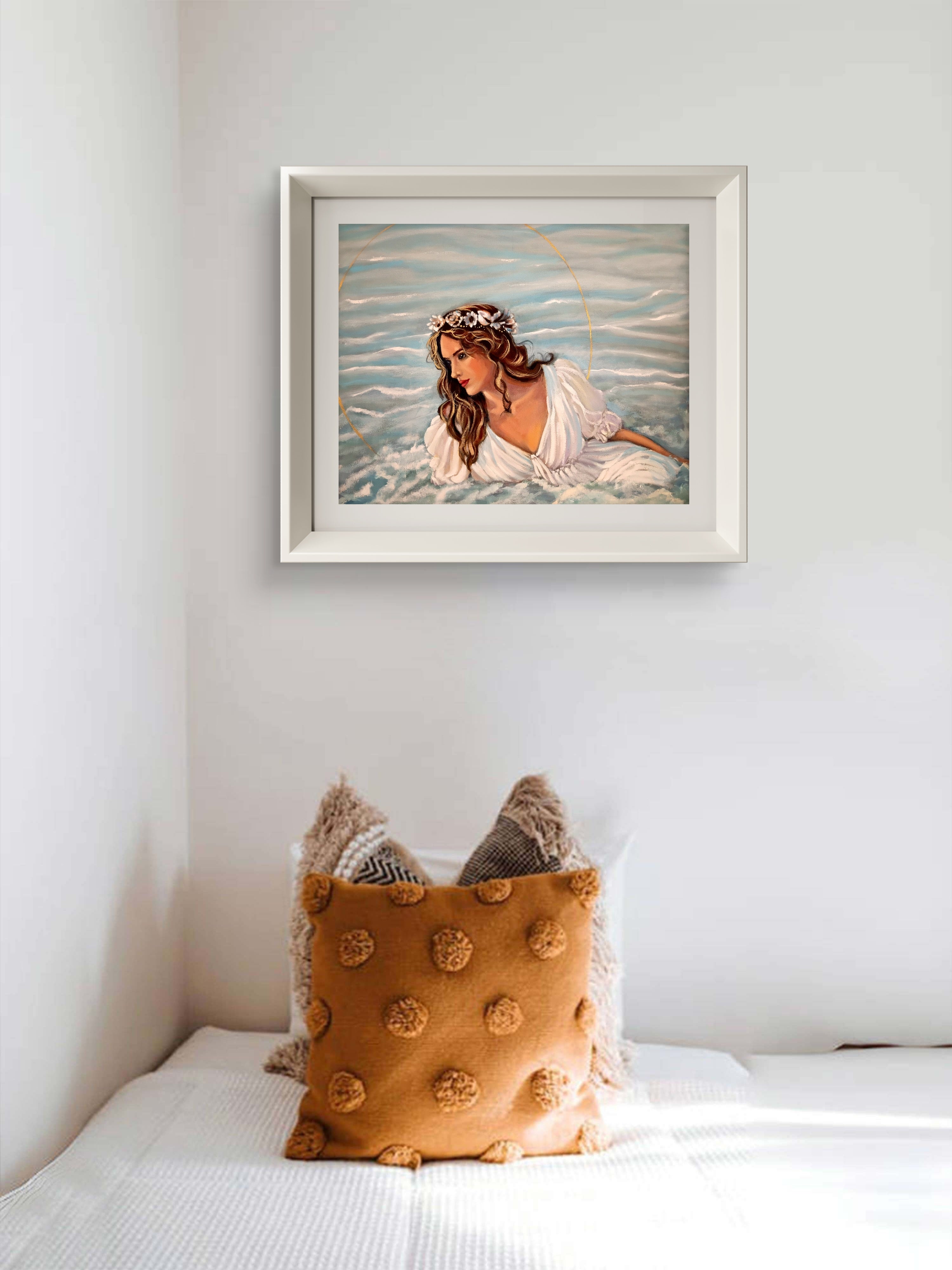 Framed artwork of a woman in water on a wall above a bed with decorative pillows.