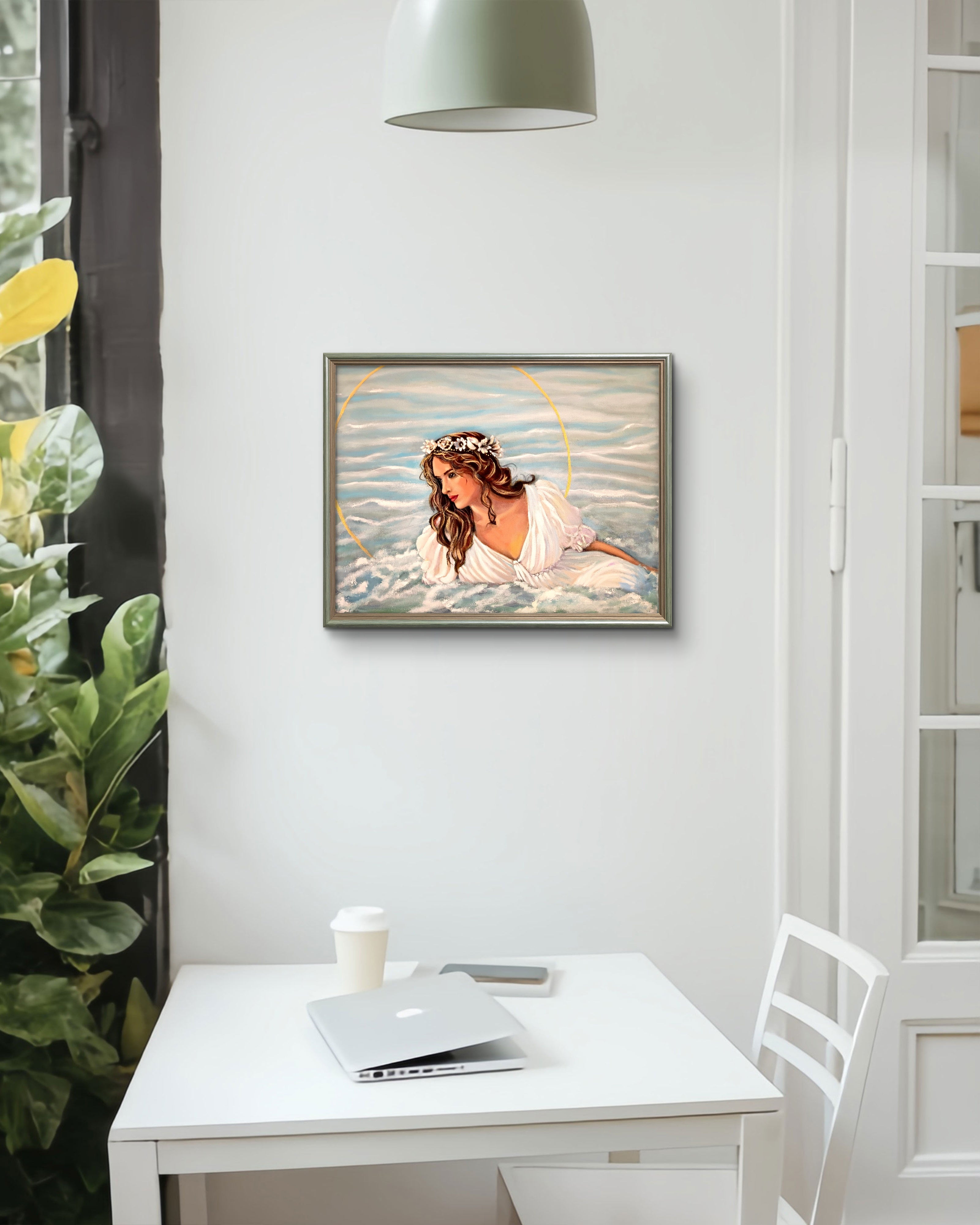Framed artwork of a woman with a flower crown on a white wall above a desk.