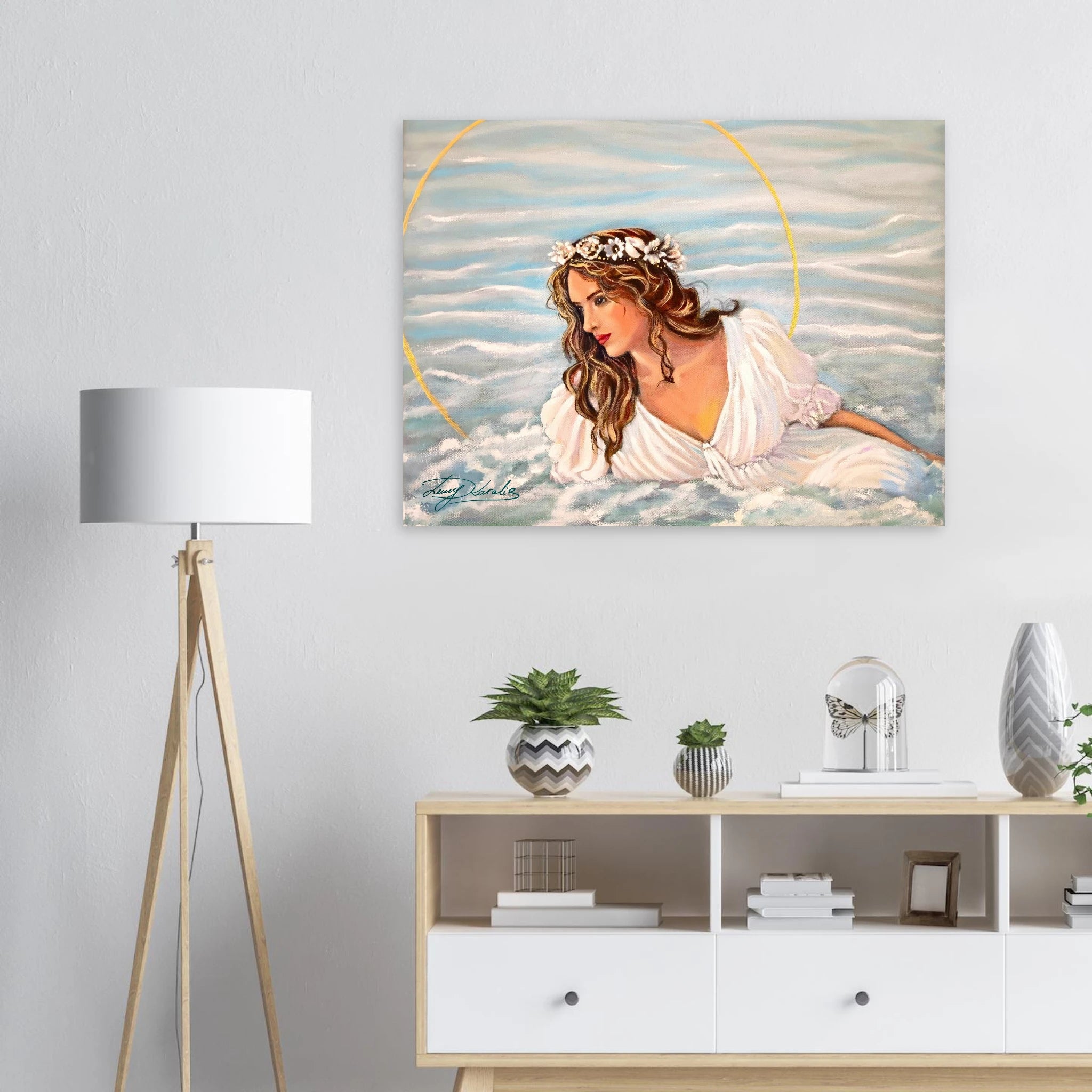 Painting of a woman with a halo on a wall above a white console table with decorative items.