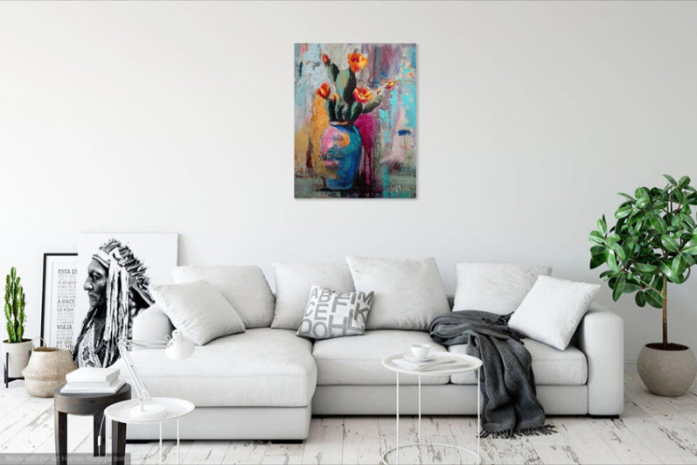 Living room with a white sofa, decorative pillows, and a colorful abstract painting on the wall.