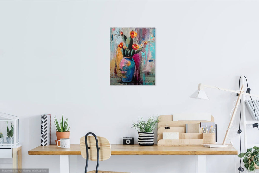 Colorful abstract painting on a wall above a desk with office supplies.