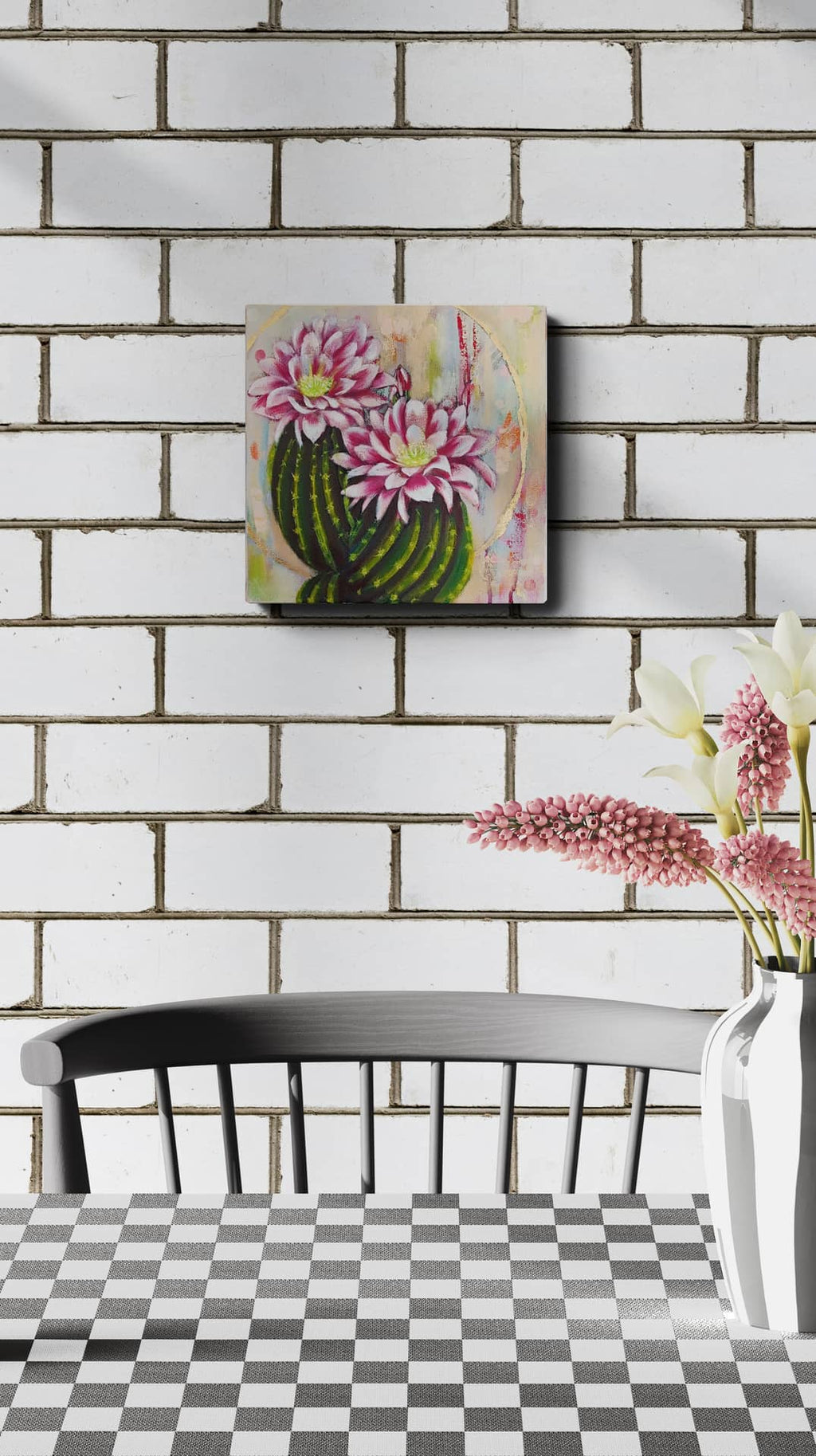 Decorative painting of pink flowers on a white brick wall above a checkered table.