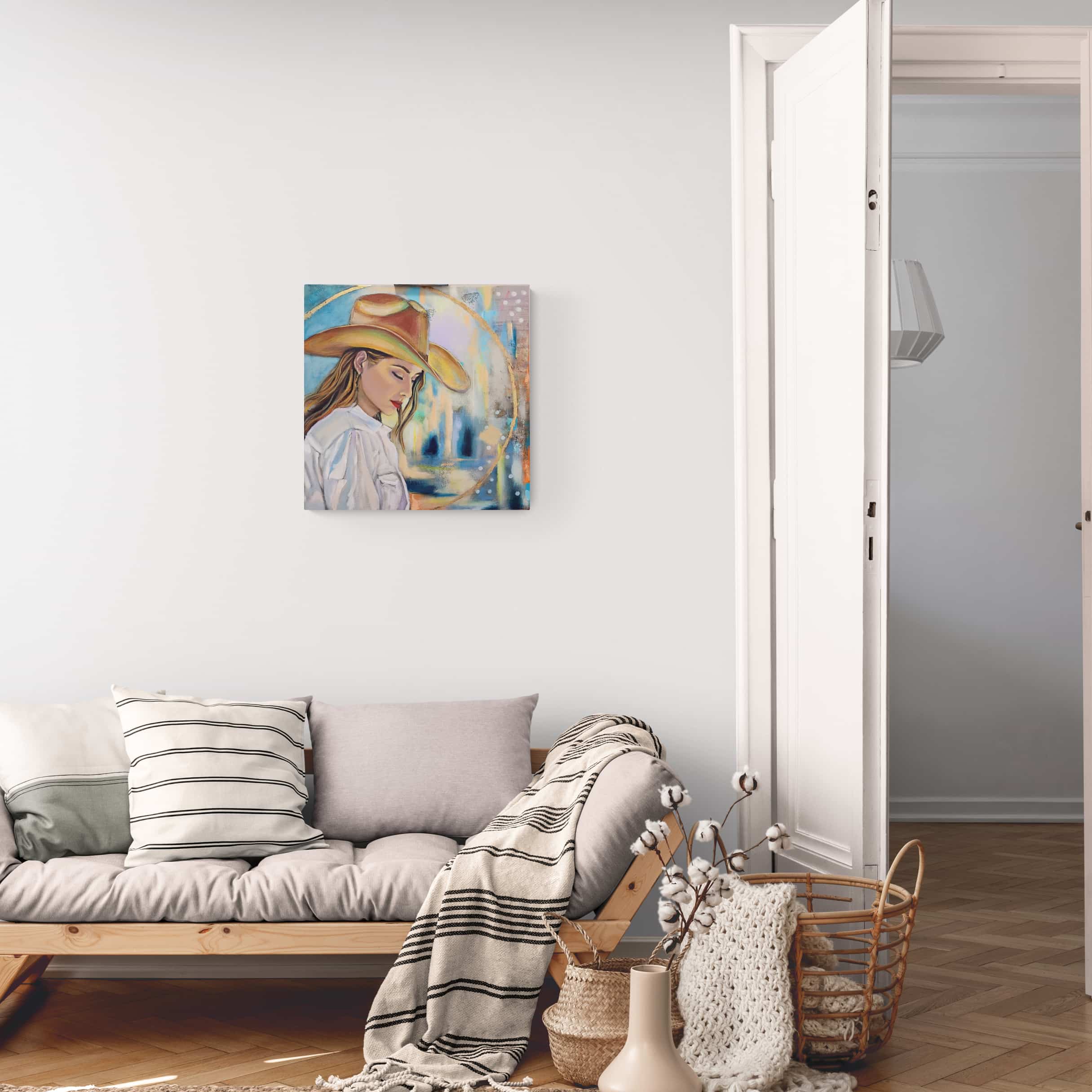 Living room with a painting of a woman wearing a hat on the wall above a sofa.