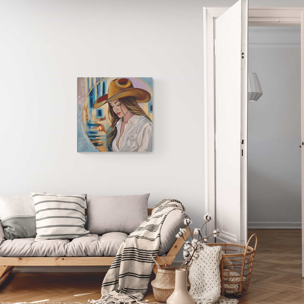 Living room with a sofa, decorative pillows, and a painting of a woman wearing a hat on the wall.