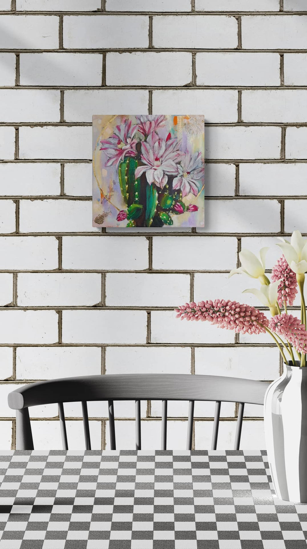 Decorative painting of flowers on a brick wall with a chair and table in the foreground.