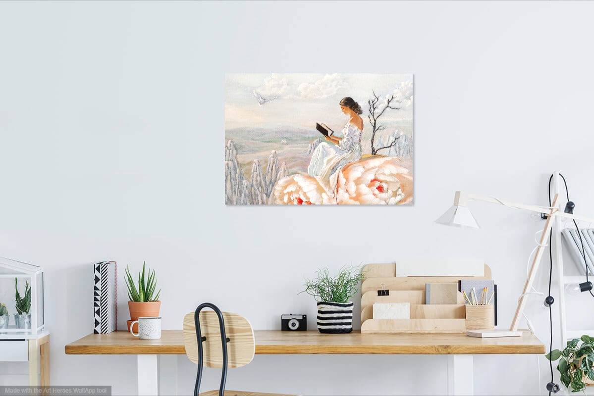 Canvas print of a woman reading a book in a snowy landscape above a desk.