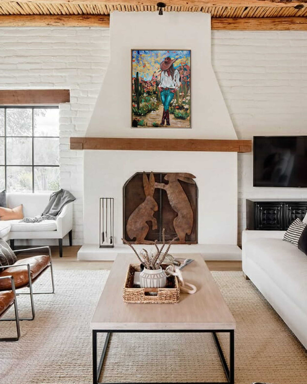 Living room with a fireplace, artwork, and modern decor.