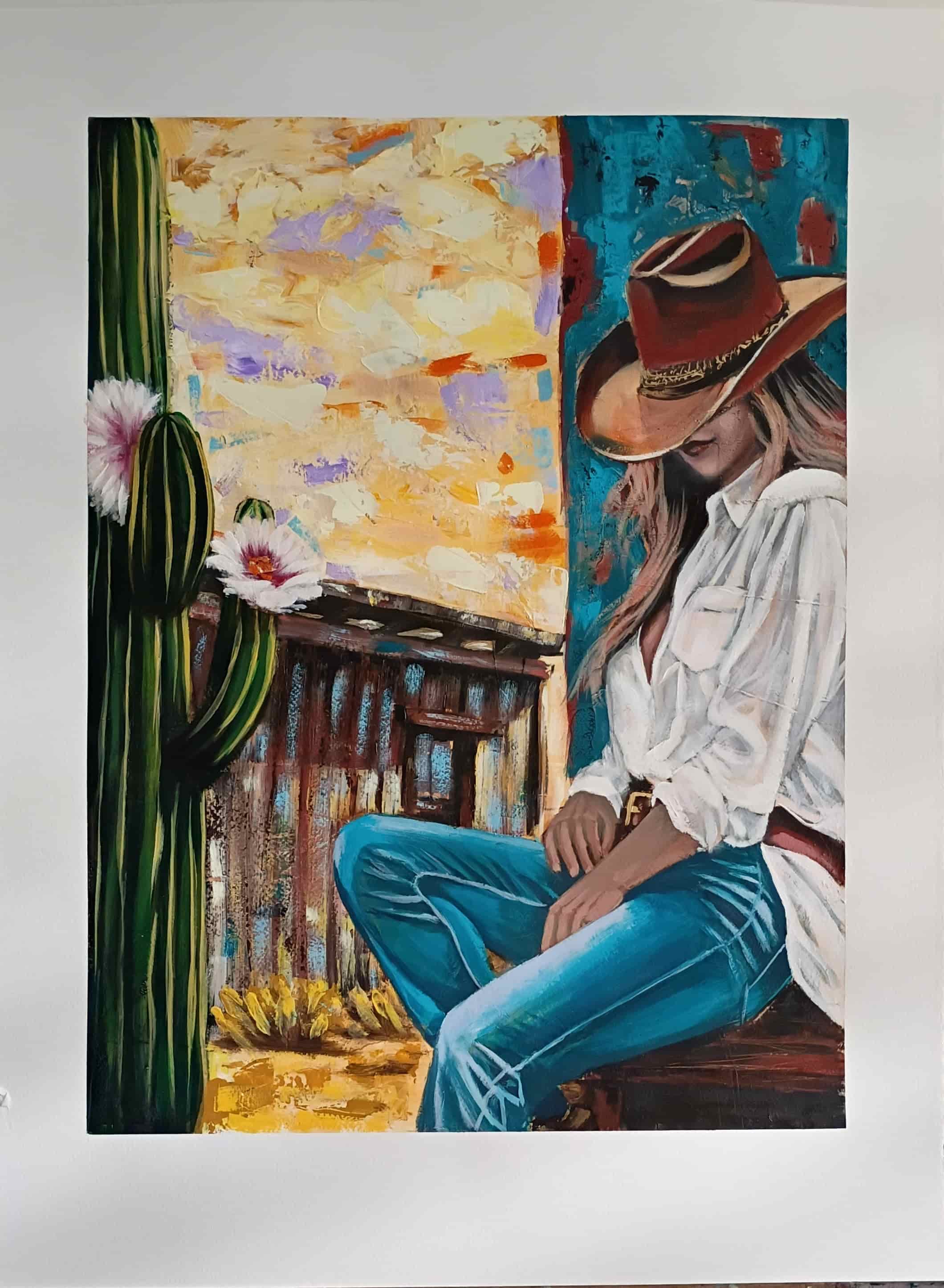 Painting of a woman in cowboy attire sitting next to a cactus with flowers.