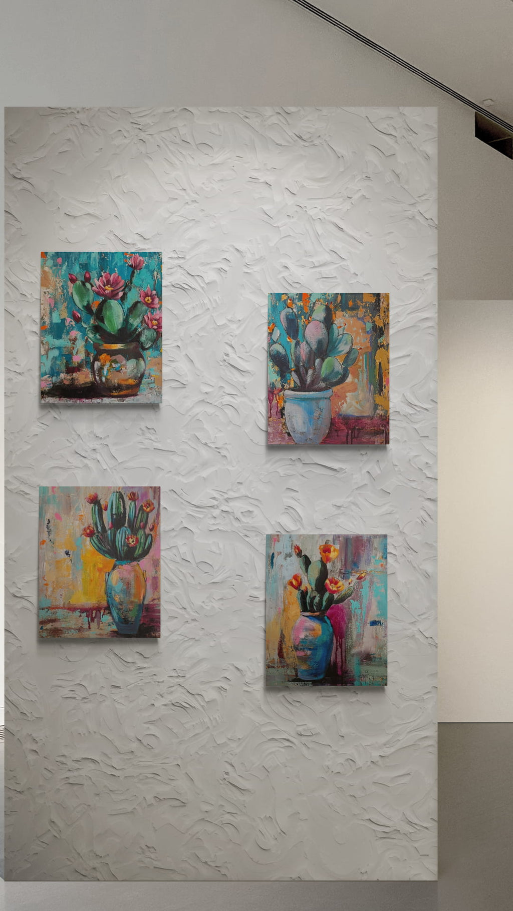 Four colorful paintings of floral and cactus scenes on a textured white wall.